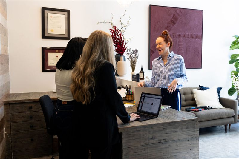 Team members talking at the practice front desk