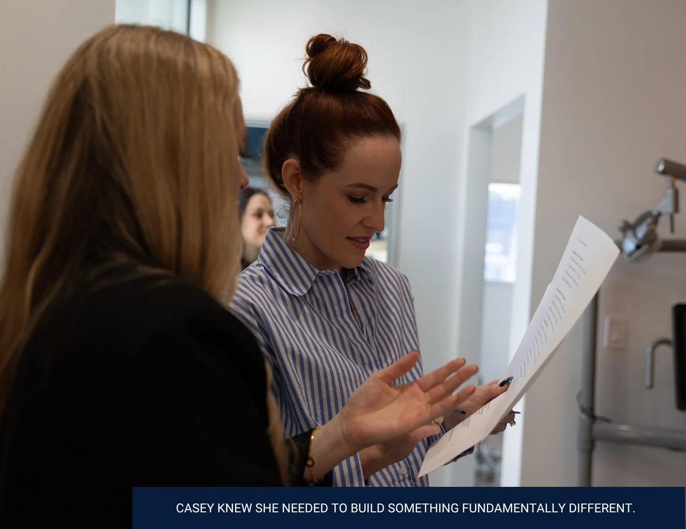 Casey reviewing a printed plan with a practice team member