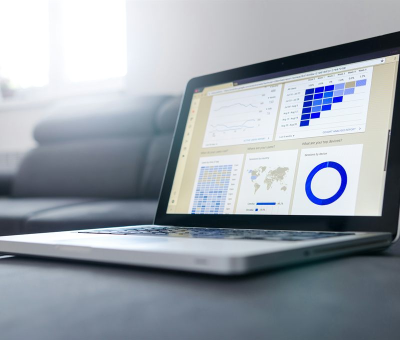 A laptop showing a market analytics dashboard