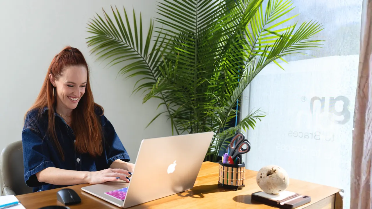 Casey working at a laptop in an orthodontic practice office