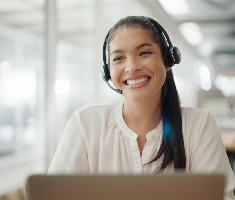 A virtual assistant on a headset at her workstation