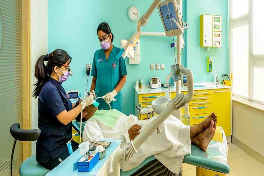 A clinical team working with a patient in the operatory