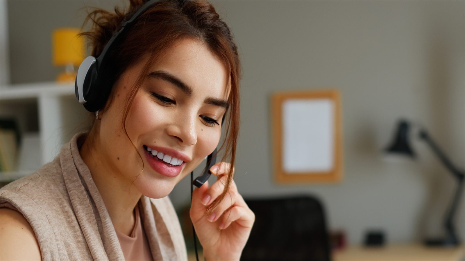 A virtual assistant on a headset at her workstation